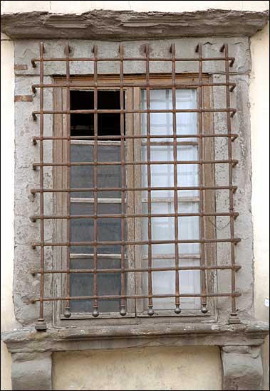 A window and grille, Lucca, Italy; February 11th, 2005